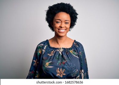 Young beautiful African American afro woman with curly hair wearing casual floral dress with a happy and cool smile on face. Lucky person.