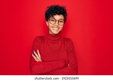 Young beautiful african american afro woman wearing turtleneck sweater and glasses happy face smiling with crossed arms looking at the camera. Positive person. - Powered by Shutterstock