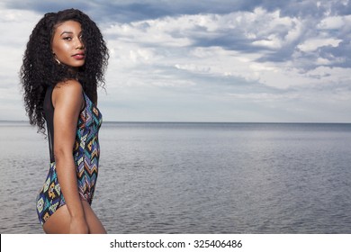 Young beautiful African American girl relaxing at the beach. - Powered by Shutterstock