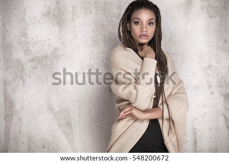 Young beautiful african american girl. Female model posing in studio.