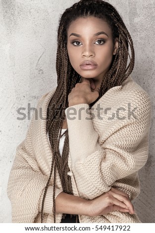 Young beautiful african american girl. Female model posing in studio.