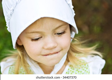 Young Beautiful Amish Child In Bonnet.