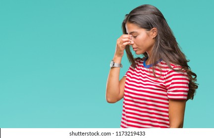Young beautiful arab woman over isolated background tired rubbing nose and eyes feeling fatigue and headache. Stress and frustration concept.