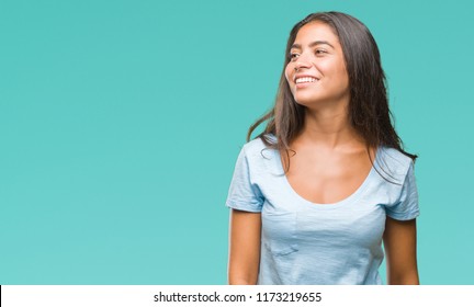Young beautiful arab woman over isolated background looking away to side with smile on face, natural expression. Laughing confident.