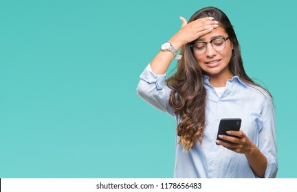 Young beautiful arab woman texting using smartphone over isolated background stressed with hand on head, shocked with shame and surprise face, angry and frustrated. Fear and upset for mistake. - Powered by Shutterstock