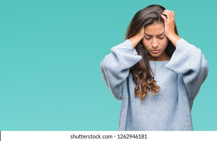 Young beautiful arab woman wearing winter sweater over isolated background suffering from headache desperate and stressed because pain and migraine. Hands on head.