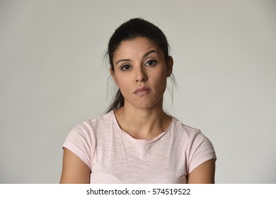 young beautiful arrogant and moody latin woman showing negative feeling and contempt facial expression isolated on grey background looking cocky and defiant 