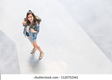 Young Beautiful Asian Backpack Traveler, Cute Woman Wearing Hat Looking Up And Smile, Top View With Copy Space. Journey Trip Lifestyle, World Travel Explorer Or Asia Summer Tropical Tourism Concept