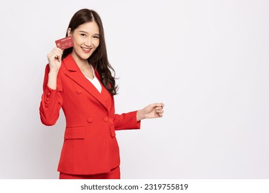 Young beautiful Asian business woman in red suit smiling holding credit card isolated on white background - Shutterstock ID 2319755819
