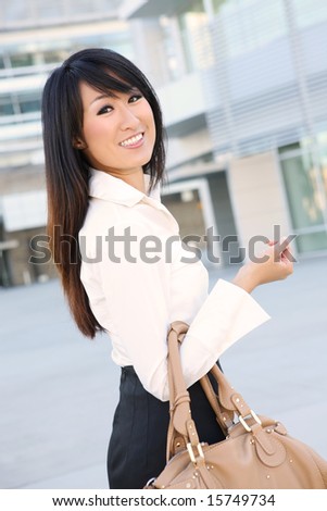 A young, beautiful asian business woman at office building