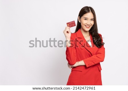 Young beautiful Asian business woman wearing red suit smiling, showing, presenting credit card for paying online business isolated on white background