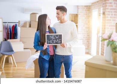 Young Beautiful Asian Couple Smiling Happy Holding Blackboard With New Home Text, Hugging In Love Moving To A New House