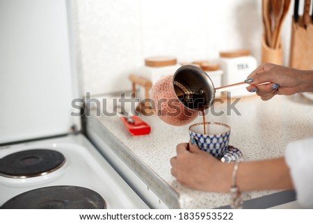 young beautiful Asian girl in beige lace shorts,white shirt preparing morning coffee. selective focus. small focus area.