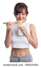 Young Beautiful Asian Girl Eating Instant Noodle Using Chopsticks.