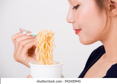 Young Beautiful Asian Girl Eating Instant Noodle Using Plastic Fork.