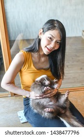 Young Beautiful Asian Lady Holding Pet Skunk