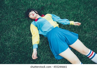 Young Beautiful Asian Millennial Woman Nonconformist Laying On The Grass Relaxing - 