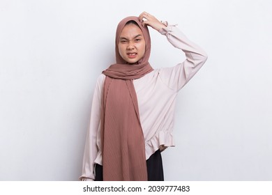 Young beautiful asian muslim woman scratching head with hand isolated on white background
 - Powered by Shutterstock