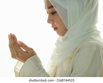 Young and beautiful Asian Muslim woman rise hands and praying with respect and calm manner. - Shutterstock ID 2168744523