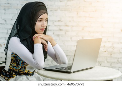 Young Beautiful Asian Muslim Woman Working With Tablet Computer.