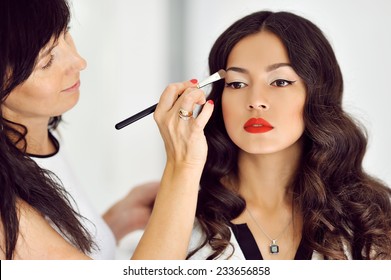 Young beautiful asian woman applying make-up by make-up artist - Shutterstock ID 233656858