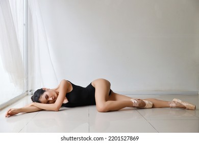 Young Beautiful Asian Woman Ballet Dancer On White Wall Studio