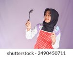 Young beautiful asian woman chef in uniform holding turner and iron Frying pan utensils cooking in the kitchen various gesture on isolated background. woman occupation chef restaurant and hotel.