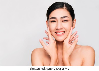 Young beautiful asian woman with clean and bright skin, Cosmetic Beauty Concept,hands touch on the cheek, smiling and friendly face isolated on grey background - Shutterstock ID 1600818742