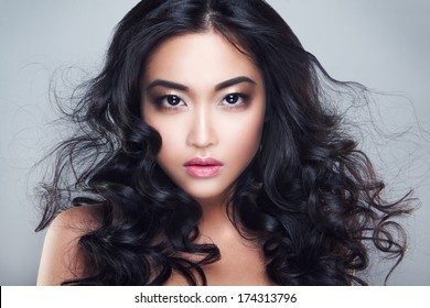 Young And Beautiful Asian Woman With Curly Hair