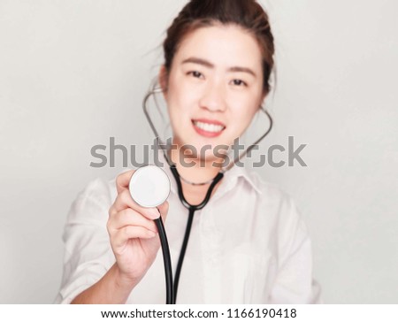 young beautiful asian woman doctor with Stethoscopes,She smile and friendly,hand check for patient,Selective focus