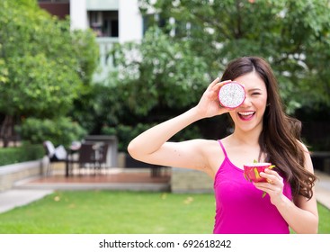 Young Beautiful Asian Woman Eating Dragon Fruits, Healthy Eating With Clean Food And Fruit For Diet Contact