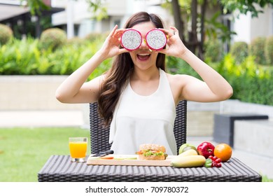 Young Beautiful Asian Woman Eating Dragon Fruits, Healthy Eating With Clean Food And Fruit For Diet Contact