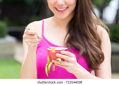 Young Beautiful Asian Woman Eating Dragon Fruits, Healthy Eating With Clean Food And Fruit For Diet Contact