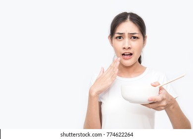 Young Beautiful Asian Woman Eating Yummy Hot And Spicy Instant Noodle Using Chopsticks Isolated On White Background. Asian Girl Servile End Of The Month With Cheap Food.