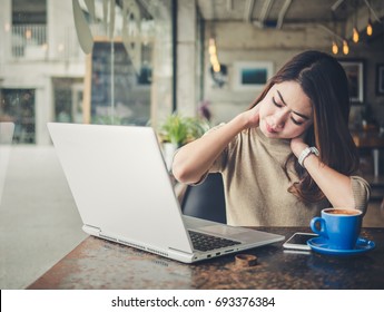 Young Beautiful Asian Woman Feeling Hurt,fatigue, Pain At Neck, Muscle During Working With Laptop In Coffee Shop Cafe, Stretching Arms And Body For Relaxing, Vintage Tone, Office Syndrome Concept