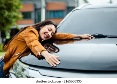 Young Beautiful Asian Woman Getting The New Car. She Hugged Her Car And Was Very Happy. Buy Or Rent Car Concept.