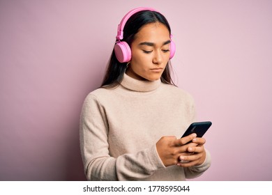 Young Beautiful Asian Woman Listening To Music Using Smartphone And Headphones With A Confident Expression On Smart Face Thinking Serious