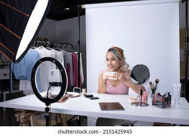 Young beautiful Asian woman and professional beauty make up artist vlogger or blogger recording makeup tutorial to share on website or social media. Business online influencer on social media concept. - Powered by Shutterstock