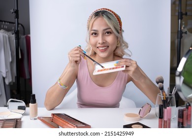 Young beautiful Asian woman and professional beauty make up artist vlogger or blogger recording makeup tutorial to share on website or social media. Business online influencer on social media concept. - Powered by Shutterstock