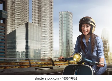 Young Beautiful Asian Woman Riding Scooter Amid The City With Very Happy