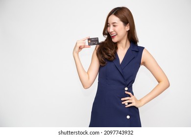 Young beautiful Asian woman smiling, showing, presenting credit card for making payment or paying online business, Pay a merchant or as a cash advance for goods, Cardholder or A person who owns a card