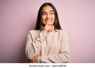 Young beautiful asian woman wearing casual turtleneck sweater over pink background with hand on chin thinking about question, pensive expression. Smiling with thoughtful face. Doubt concept. - Shutterstock ID 1661148934