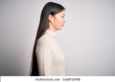 Young Beautiful Asian Woman Wearing Casual Sweater Standing Over Isolated Background Looking To Side, Relax Profile Pose With Natural Face With Confident Smile.