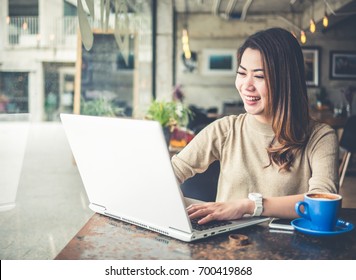 Young Beautiful Asian Woman Working In Coffee Shop Cafe, Using Computer Laptop About Business Work And Online Shopping, Smile And Happy With Copy Space, Vintage Tone