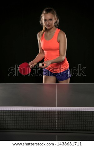 young beautiful athletic girl playing ping pong