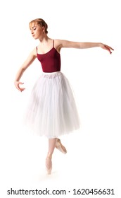 Young Beautiful Ballerina In White Tutu And Pointe Shoes Doing Dancing Pose Over White Background. Ballet, Grace, Beauty, Art Concept