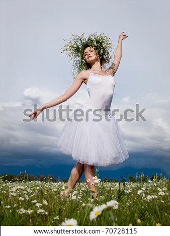young beautiful ballet dancer against cloudy sky