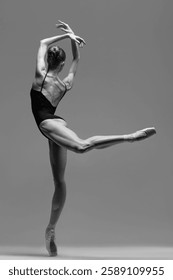 Young beautiful ballet dancer is posing in studio