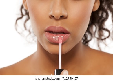 young beautiful black woman applied lipstick