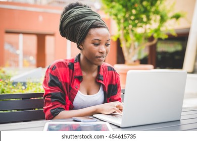 Young Beautiful Black Woman  Sitting Using A Computer, Tapping On The Keyboard - University, Technology, Business Concept